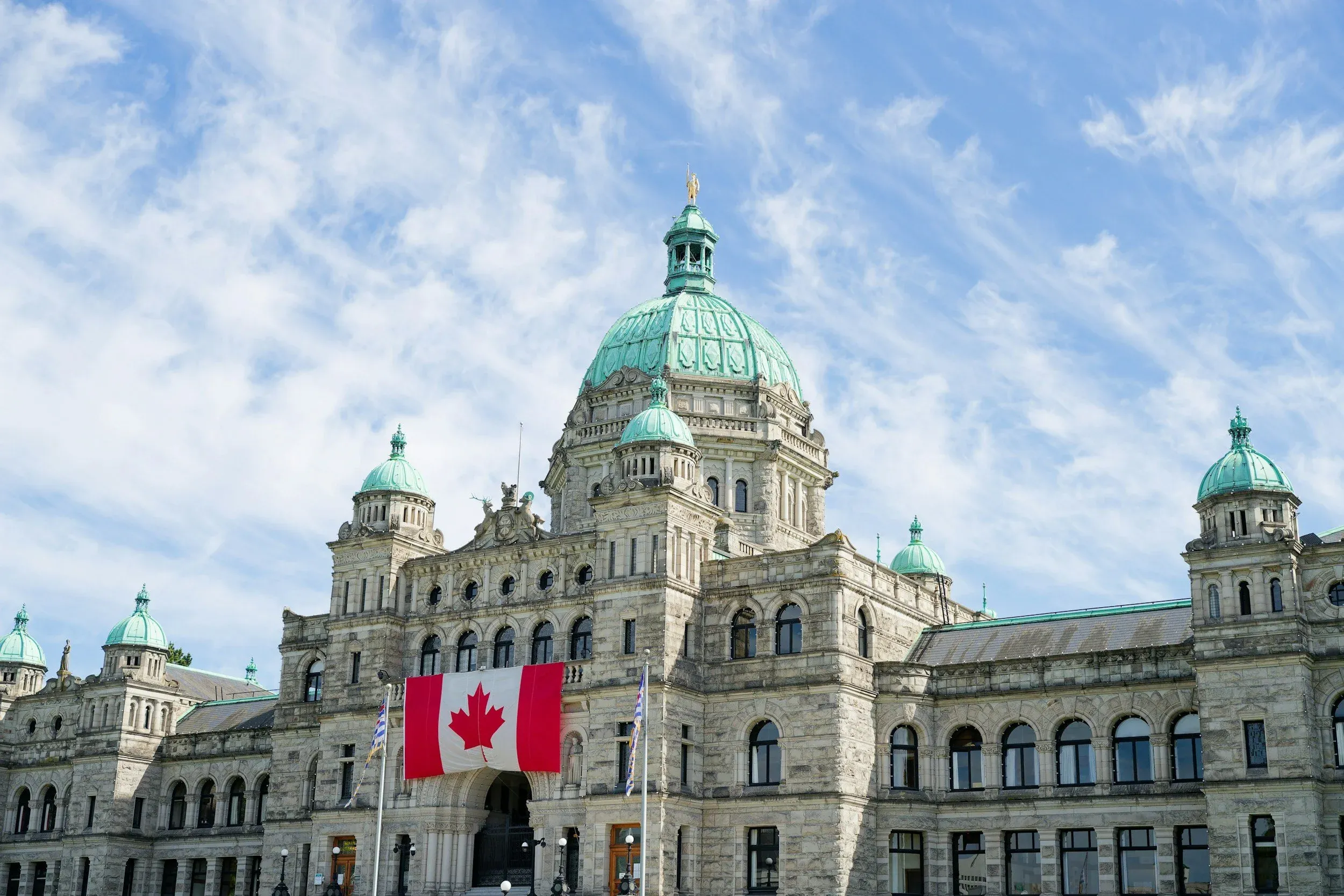 Canadian flag in front of the Parliament Buildings in Victoria, British Columbia